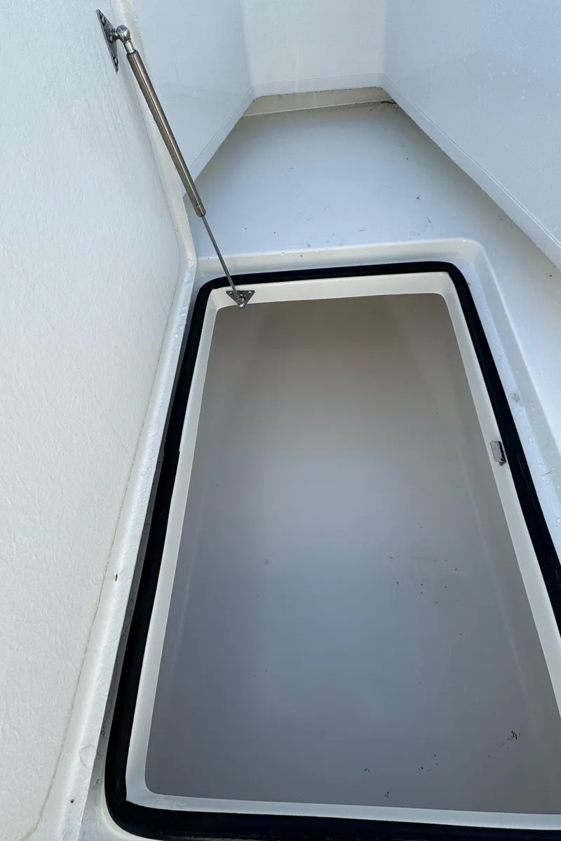 Slide: The Image of 2025 Pair Customs 24 Center Console DV storage compartment, open and empty. - 7