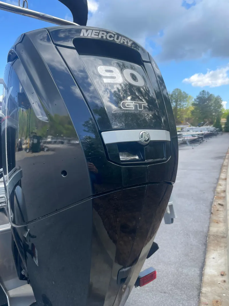 Slide: The Image of Mercury 90 GT engine on a 2023 Bennington 20SV boat, parked outdoors. - 2