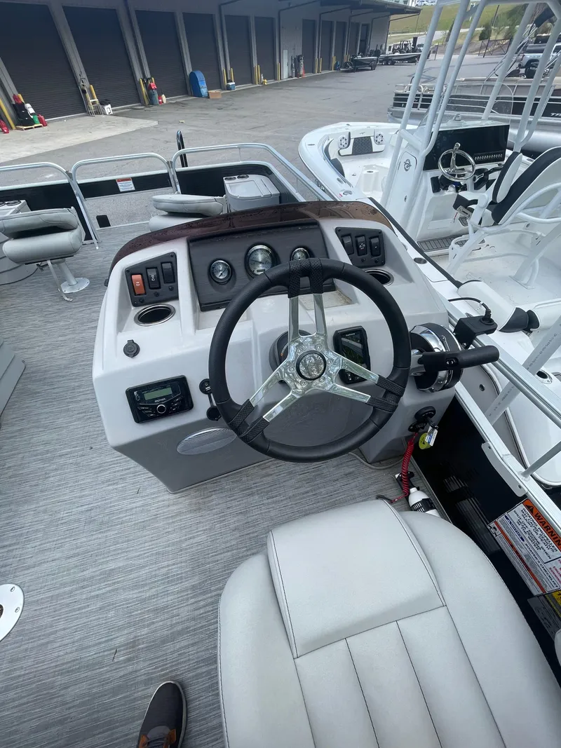 Slide: The Image of 2023 Bennington 20SV boat dashboard with steering wheel and control panel. - 8