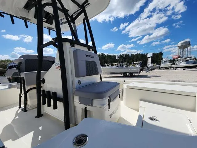 Slide: The Image of 2025 Pathfinder 2300 HPS boat interior with seating, under a clear blue sky. - 10