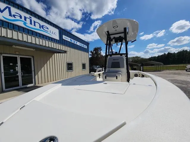 Slide: The Image of 2025 Pathfinder 2300 HPS boat outside a marine dealership under a blue sky. - 12