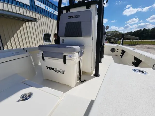 Slide: The Image of 2025 Pathfinder 2300 HPS boat with seating and storage, docked under a clear blue sky. - 14