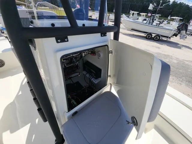 Slide: The Image of 2025 Pathfinder 2300 HPS boat console with open storage compartment and visible wiring. - 29