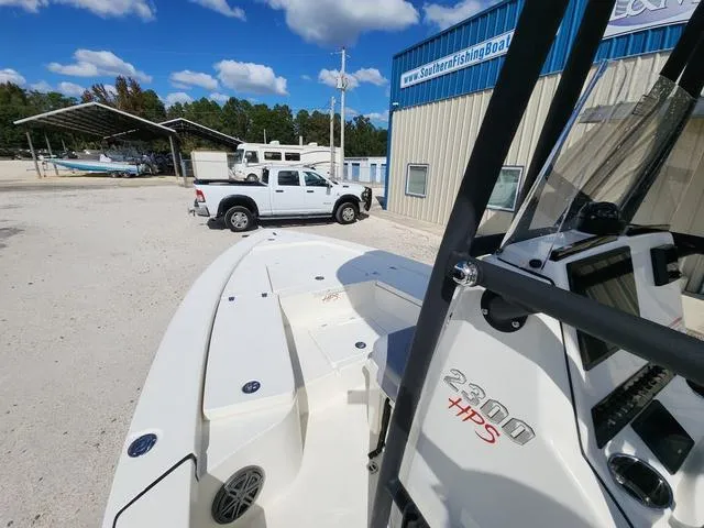 Slide: The Image of 2025 Pathfinder 2300 HPS boat parked near a fishing boat dealership. - 33