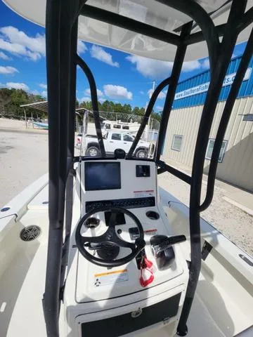 Slide: The Image of 2025 Pathfinder 2300 HPS boat console with steering wheel and navigation system. - 34