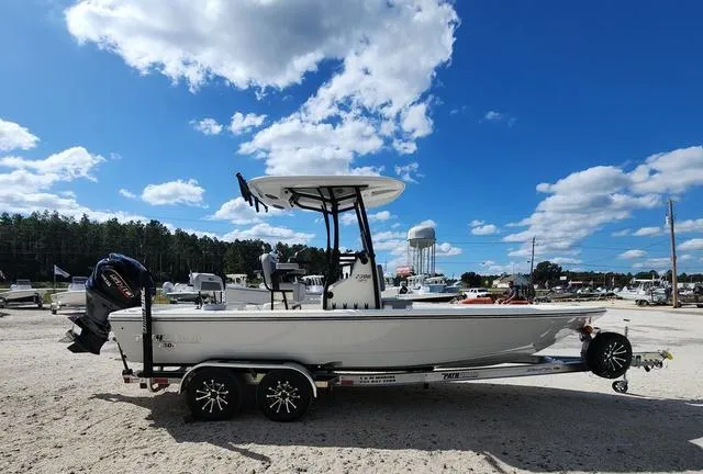 Slide: The Image of 2025 Pathfinder 2300 HPS boat on trailer under blue sky with clouds. - 4