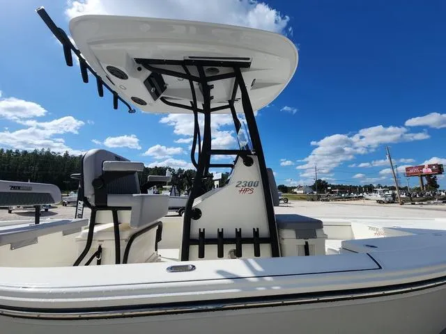 Slide: The Image of 2025 Pathfinder 2300 HPS boat with T-top, under a clear blue sky. - 7