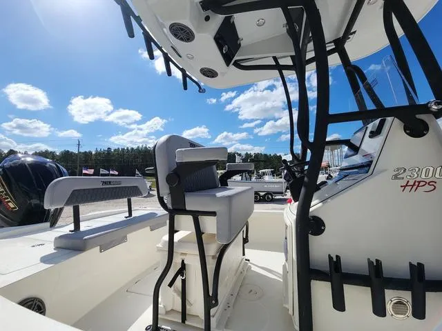 Slide: The Image of 2025 Pathfinder 2300 HPS boat interior with seating and console under a sunny sky. - 8