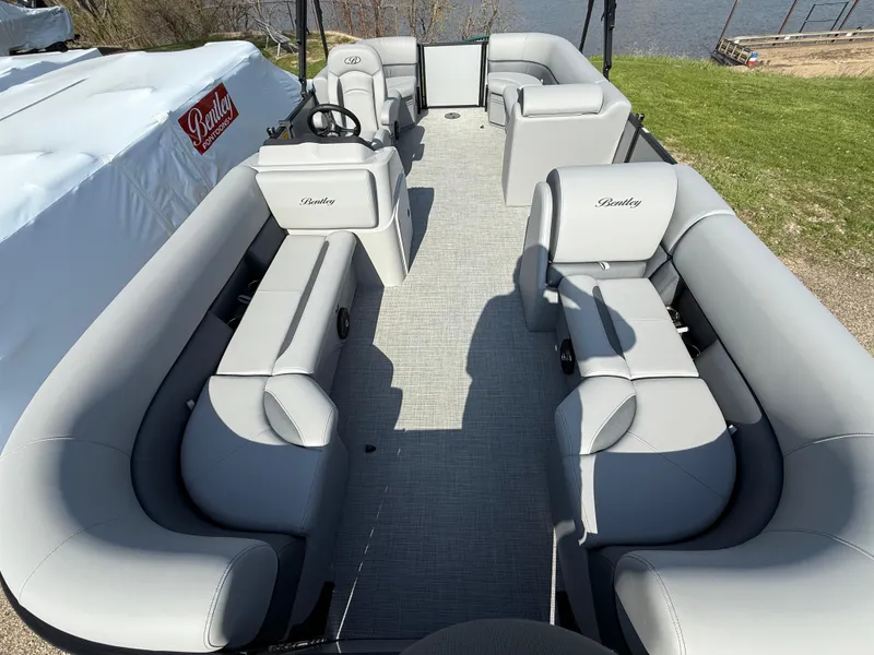 Slide: The Image of 2025 Bentley Pontoons LE 200 CW with spacious seating and modern design on a sunny day. - 11
