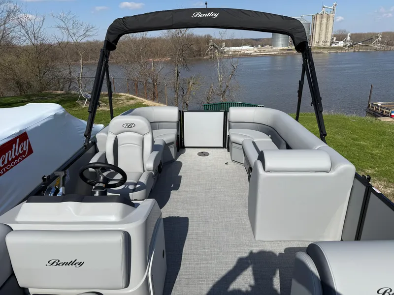 Slide: The Image of 2025 Bentley Pontoons LE 200 CW on a river, featuring spacious seating and sleek design. - 12