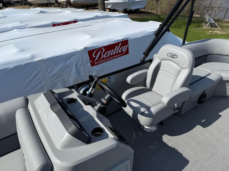 Slide: The Image of 2025 Bentley Pontoons LE 200 CW interior with steering console and seating. - 13