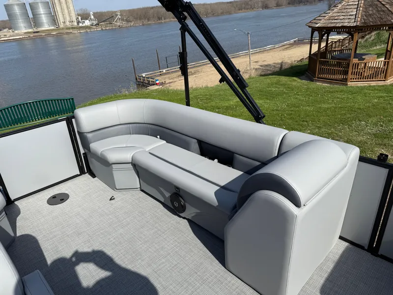 Slide: The Image of 2025 Bentley Pontoons LE 200 CW with gray seating, docked by a river. - 16