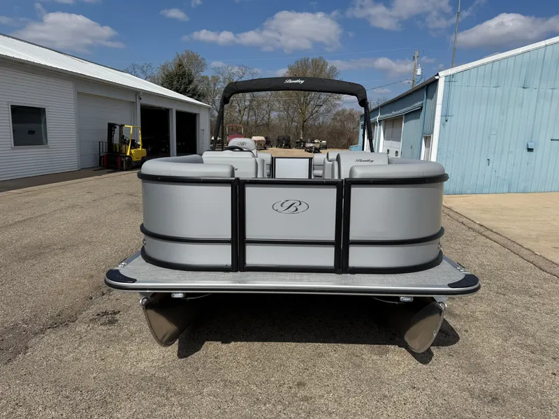 Slide: The Image of 2025 Bentley Pontoons LE 200 CW pontoon boat parked outdoors on a sunny day. - 2