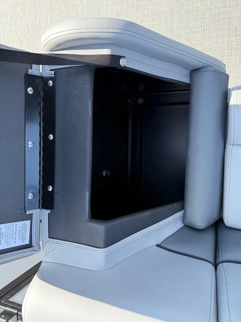 Slide: The Image of 2025 Bentley Pontoons LE 200 CW storage compartment with open lid, showcasing interior space. - 20