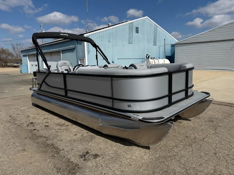 Slide: The Image of 2025 Bentley Pontoons LE 200 CW pontoon boat parked outdoors under a blue sky. - 3