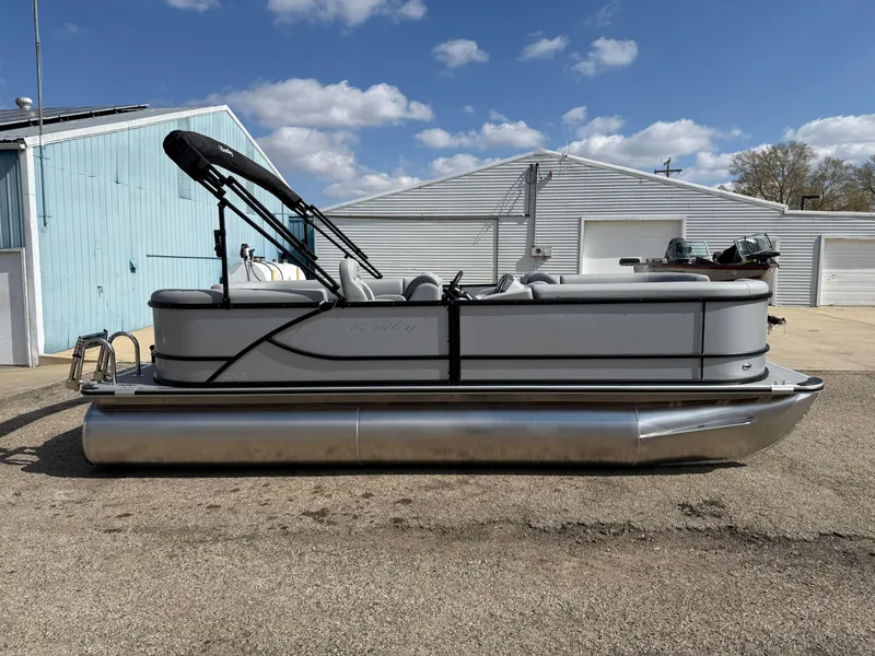 Slide: The Image of 2025 Bentley Pontoons LE 200 CW pontoon boat parked outdoors under a blue sky. - 4