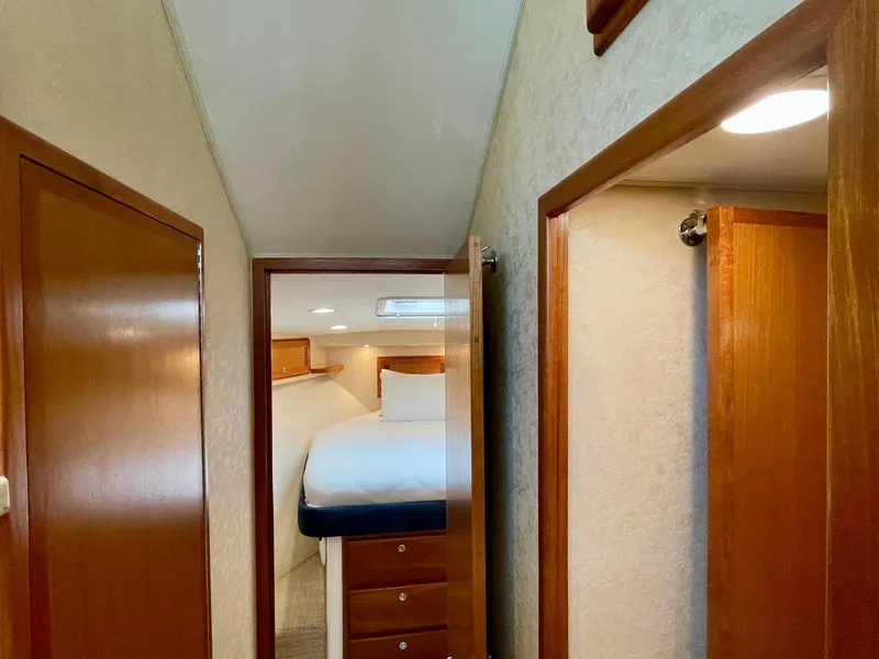 Slide: The Image of Interior view of 2006 Cabo 40 Flybridge yacht cabin with bed and wooden cabinetry. - 13