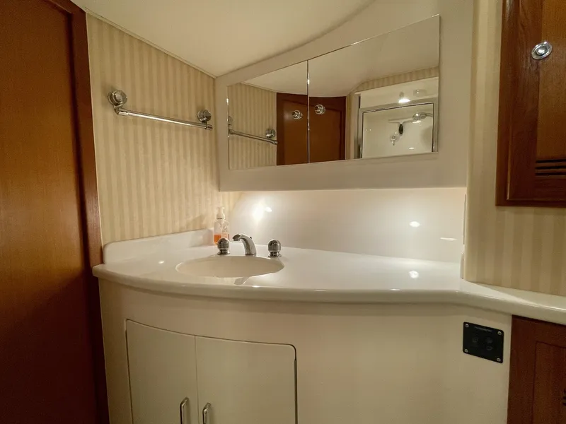 Slide: The Image of Luxurious bathroom in 2006 Cabo 40 Flybridge yacht with modern fixtures and ample storage. - 15