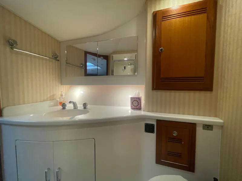Slide: The Image of Luxurious bathroom in 2006 Cabo 40 Flybridge yacht with wooden cabinets and modern fixtures. - 16