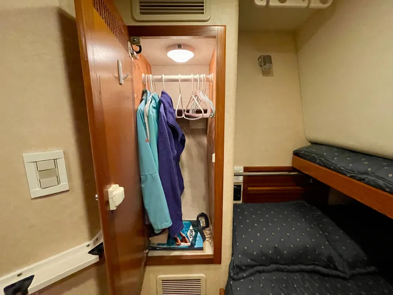 Slide: The Image of Cozy cabin interior of 2006 Cabo 40 Flybridge with closet and bunk beds. - 19