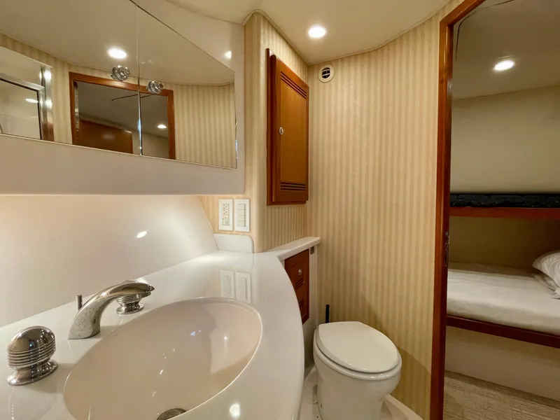Slide: The Image of Luxurious bathroom in 2006 Cabo 40 Flybridge yacht with modern fixtures and elegant design. - 22