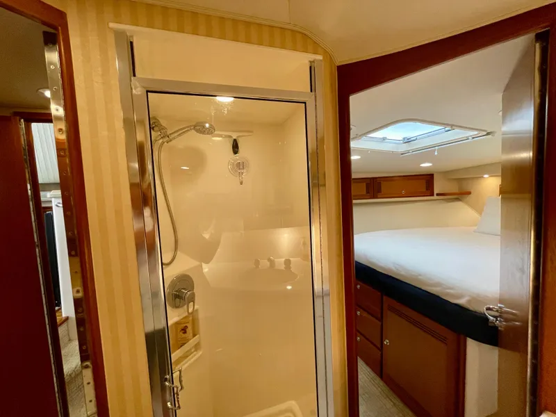 Slide: The Image of Interior of 2006 Cabo 40 Flybridge yacht with shower and cozy bedroom. - 23