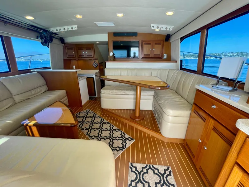 Slide: The Image of Luxurious interior of 2006 Cabo 40 Flybridge yacht with leather seating and wooden accents. - 27