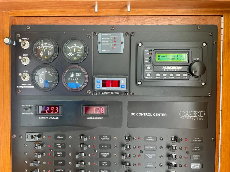 Slide: The Image of Control panel of a 2006 Cabo 40 Flybridge boat with gauges and switches. - 29