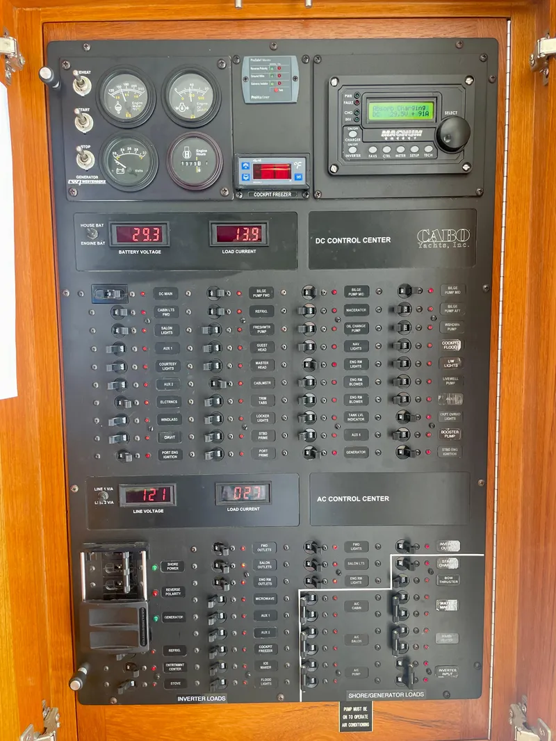 Slide: The Image of Electrical control panel of a 2006 Cabo 40 Flybridge boat, featuring gauges and switches. - 30