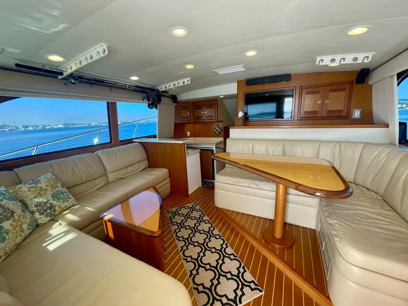 Slide: The Image of Luxurious 2006 Cabo 40 Flybridge interior with plush seating and elegant wood finishes. - 34
