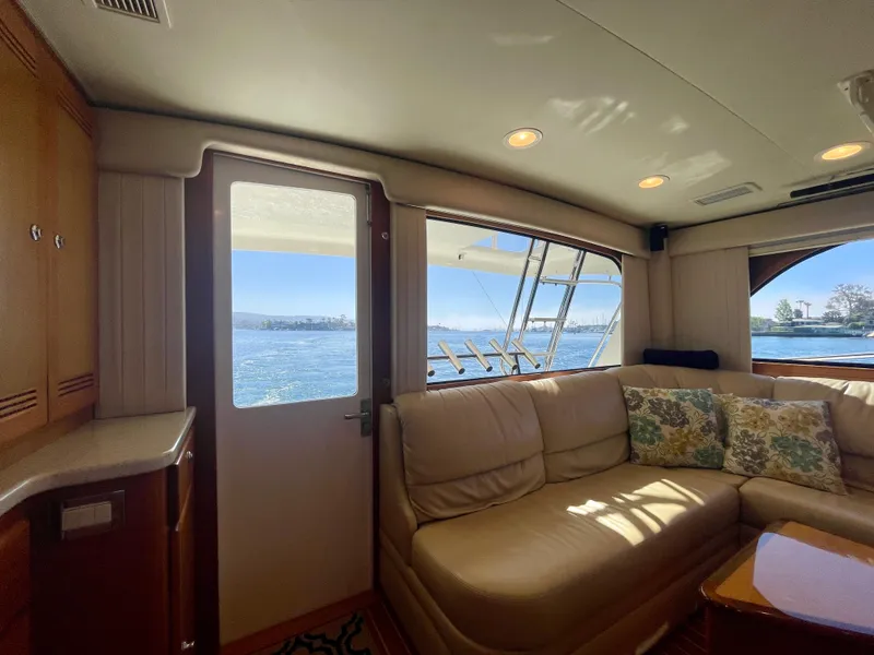 Slide: The Image of Interior of 2006 Cabo 40 Flybridge yacht with beige seating and ocean view. - 44