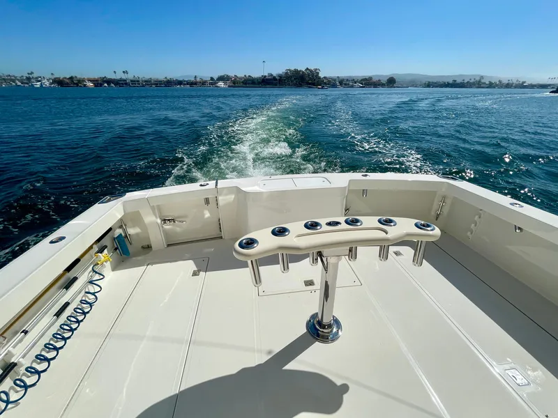 Slide: The Image of 2006 Cabo 40 Flybridge boat deck with ocean view and fishing rod holders. - 49