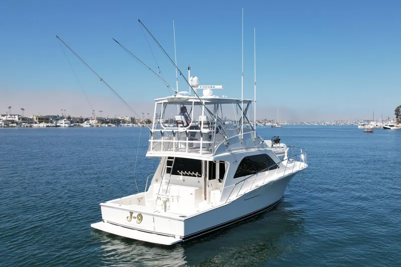 Slide: The Image of 2006 Cabo 40 Flybridge yacht cruising on calm blue waters. - 5