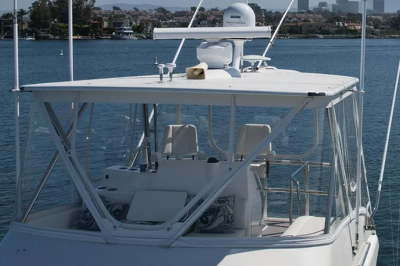 Slide: The Image of 2006 Cabo 40 Flybridge yacht on calm water, featuring a spacious upper deck. - 9