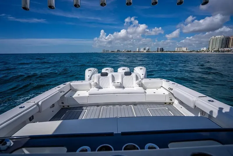 Slide: The Image of 2019 HCB 53 Sueños boat on open water with city skyline in background. - 10