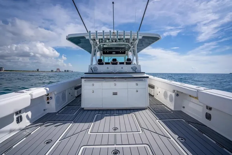 Slide: The Image of 2019 HCB 53 Sueños boat on open water, featuring spacious deck and modern design. - 12