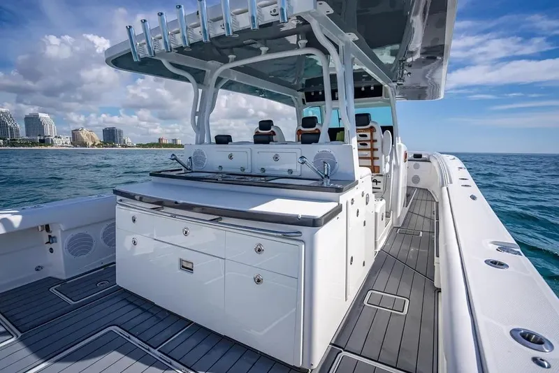 Slide: The Image of 2019 HCB 53 Sueños boat with sleek deck design, cruising on open water. - 14