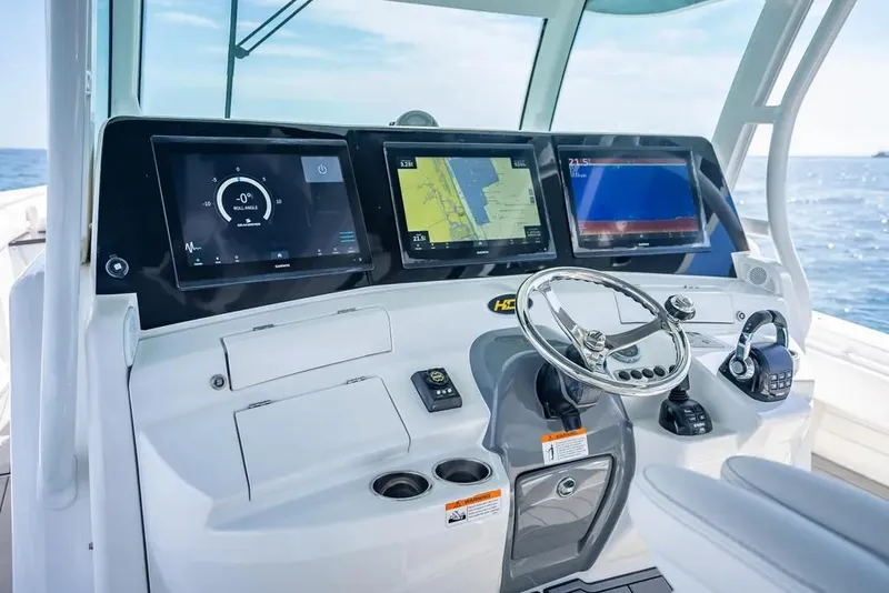Slide: The Image of 2019 HCB 53 Sueños boat dashboard with advanced navigation screens and controls. - 22