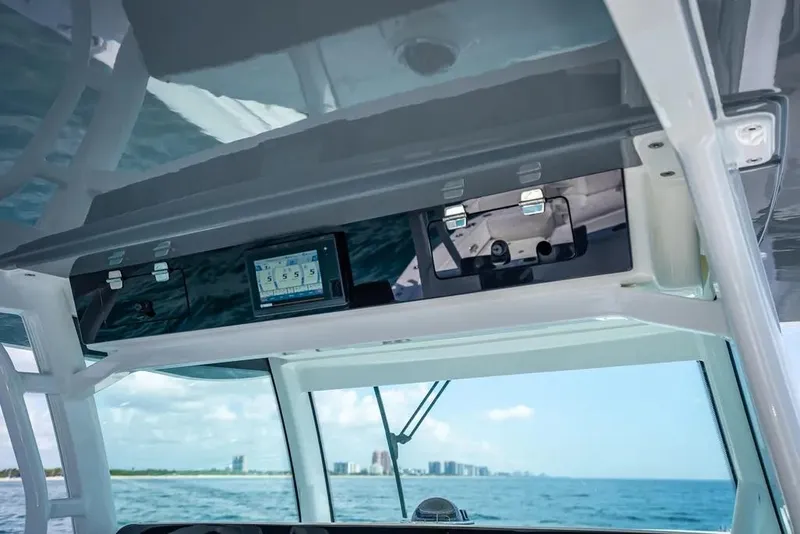 Slide: The Image of Interior view of 2019 HCB 53 Sueños boat with navigation equipment and ocean backdrop. - 24