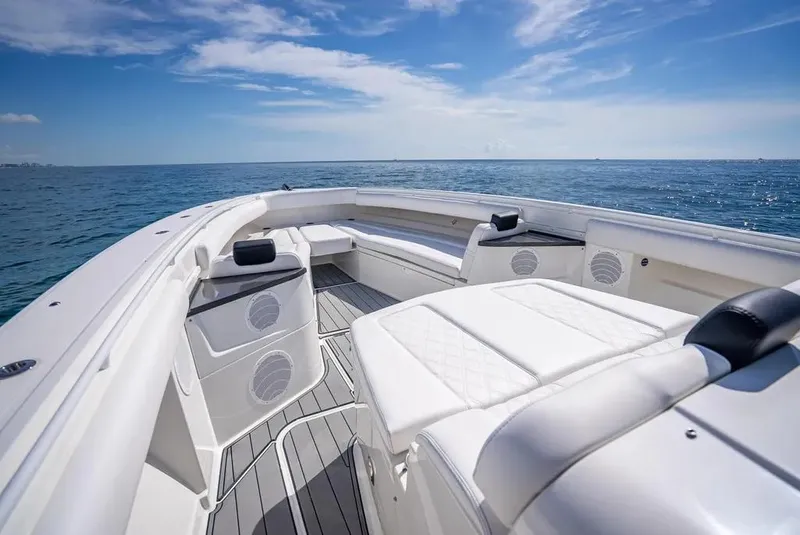 Slide: The Image of 2019 HCB 53 Sueños boat with spacious deck and seating, cruising on open sea. - 25