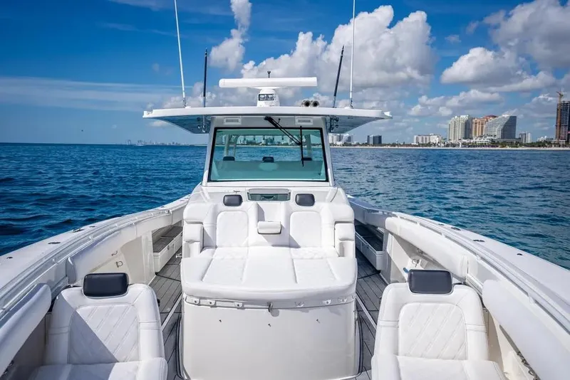 Slide: The Image of 2019 HCB 53 Sueños boat on open water with city skyline in background. - 29