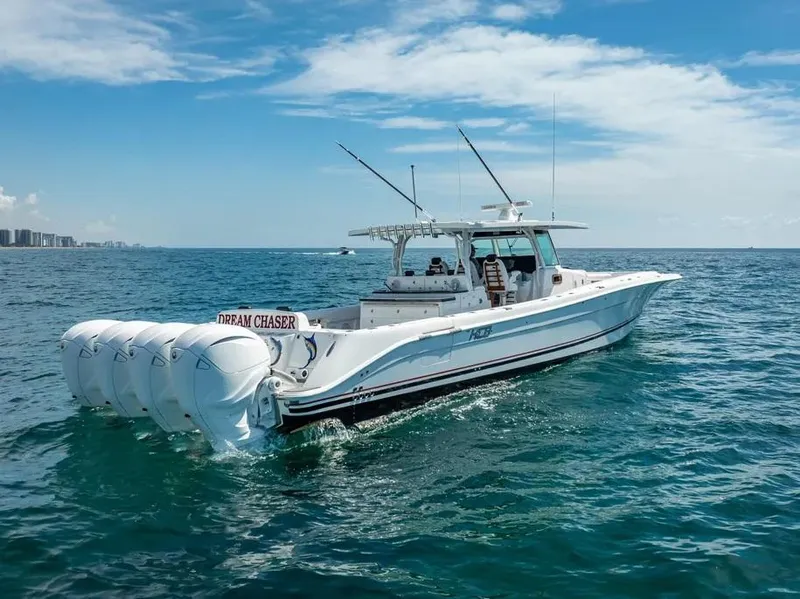 Slide: The Image of 2019 HCB 53 Sueños boat cruising on open water under a clear blue sky. - 3