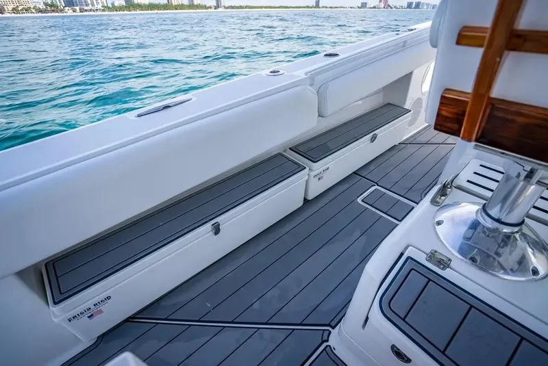 Slide: The Image of 2019 HCB 53 Sueños boat deck with sleek seating and storage, overlooking calm blue waters. - 31