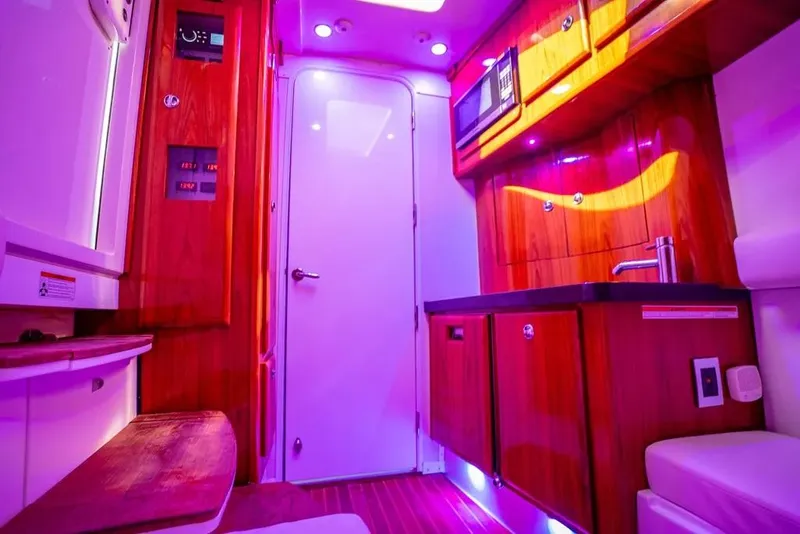 Slide: The Image of Luxurious interior of 2019 HCB 53 Sueños boat with vibrant lighting and wooden cabinetry. - 35