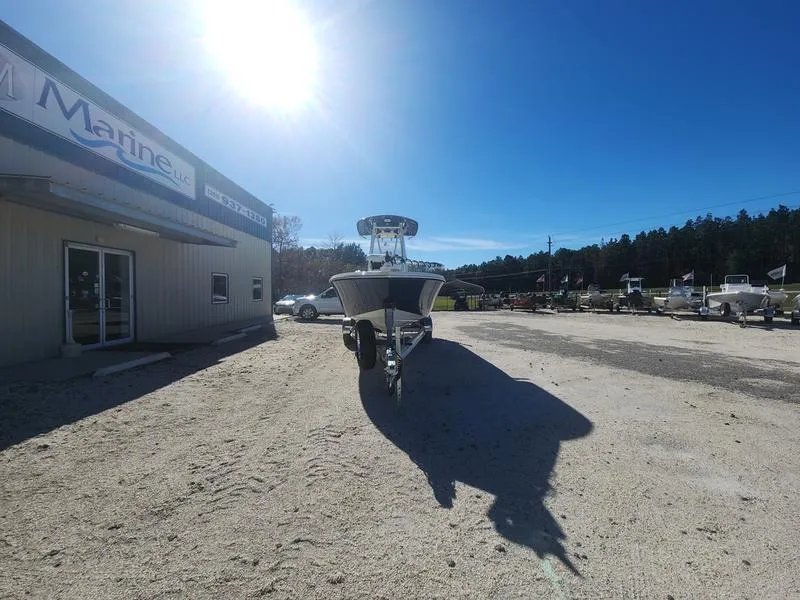 Slide: The Image of 2025 Pathfinder 2400 Open boat on trailer in sunny outdoor dealership lot. - 1