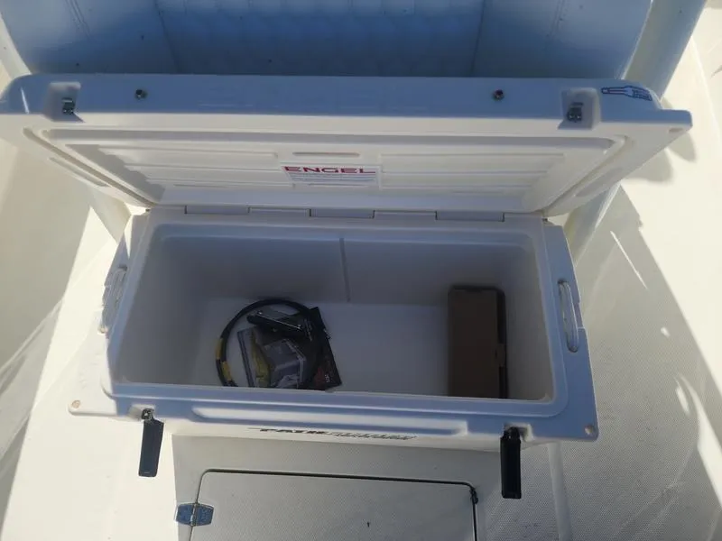 Slide: The Image of Open cooler on 2025 Pathfinder 2400 Open boat deck, containing gear and accessories. - 10