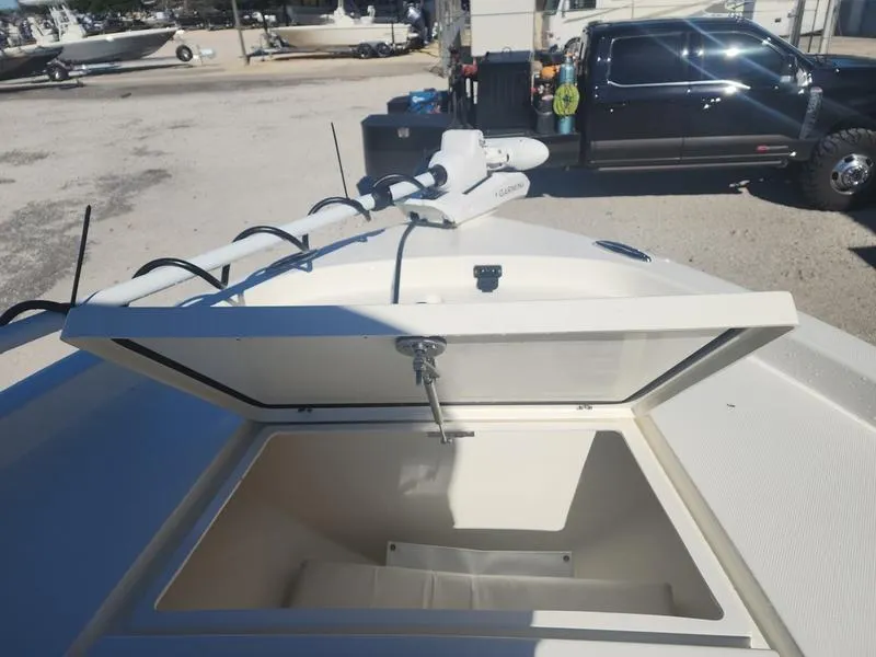 Slide: The Image of 2025 Pathfinder 2400 Open boat with open storage compartment and trolling motor. - 12