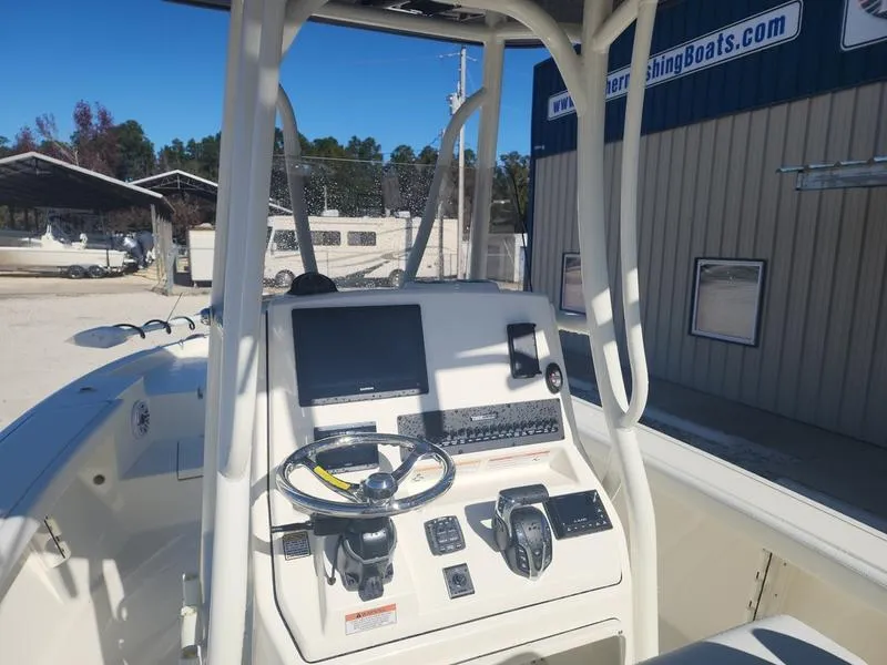 Slide: The Image of 2025 Pathfinder 2400 Open boat dashboard with steering wheel and navigation controls. - 15