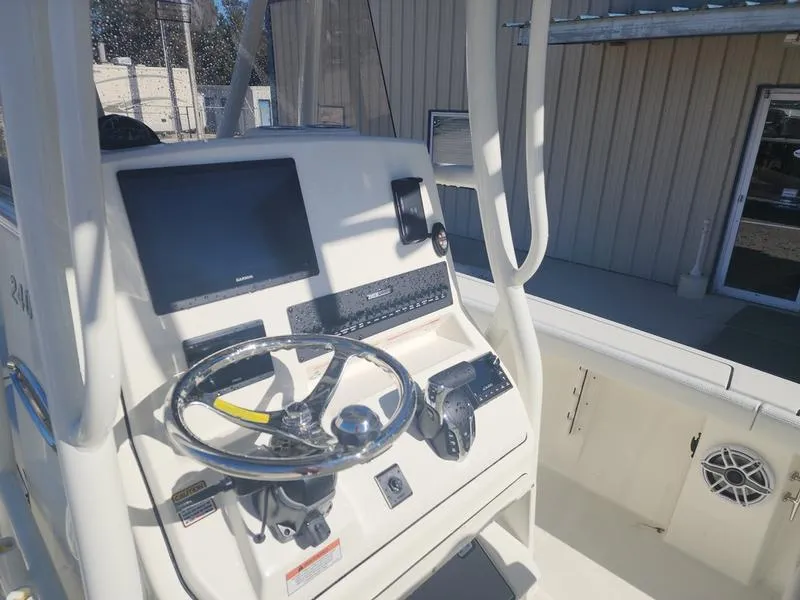 Slide: The Image of 2025 Pathfinder 2400 Open boat console with steering wheel and navigation equipment. - 18
