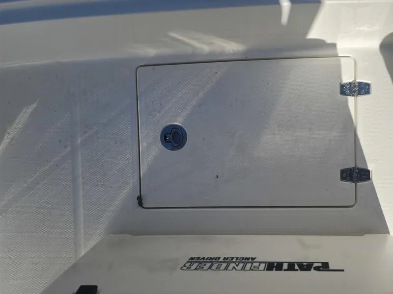 Slide: The Image of 2025 Pathfinder 2400 Open boat deck with storage compartment and TAHOE branding. - 23